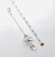 A silver-toned crystal fairy angel with a teardrop crystal pendant and a spiral end, shown next to a measuring tape on a white background.