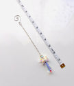 A silver beaded chain with a crystal angel and a spiral end, shown on a white background next to a measuring tape for scaled.