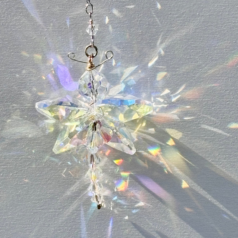 Unique artisan butterfly suncatcher made of rare Swarovski crystals being illuminated by the sun and casting amazing rainbows and sparkle.  