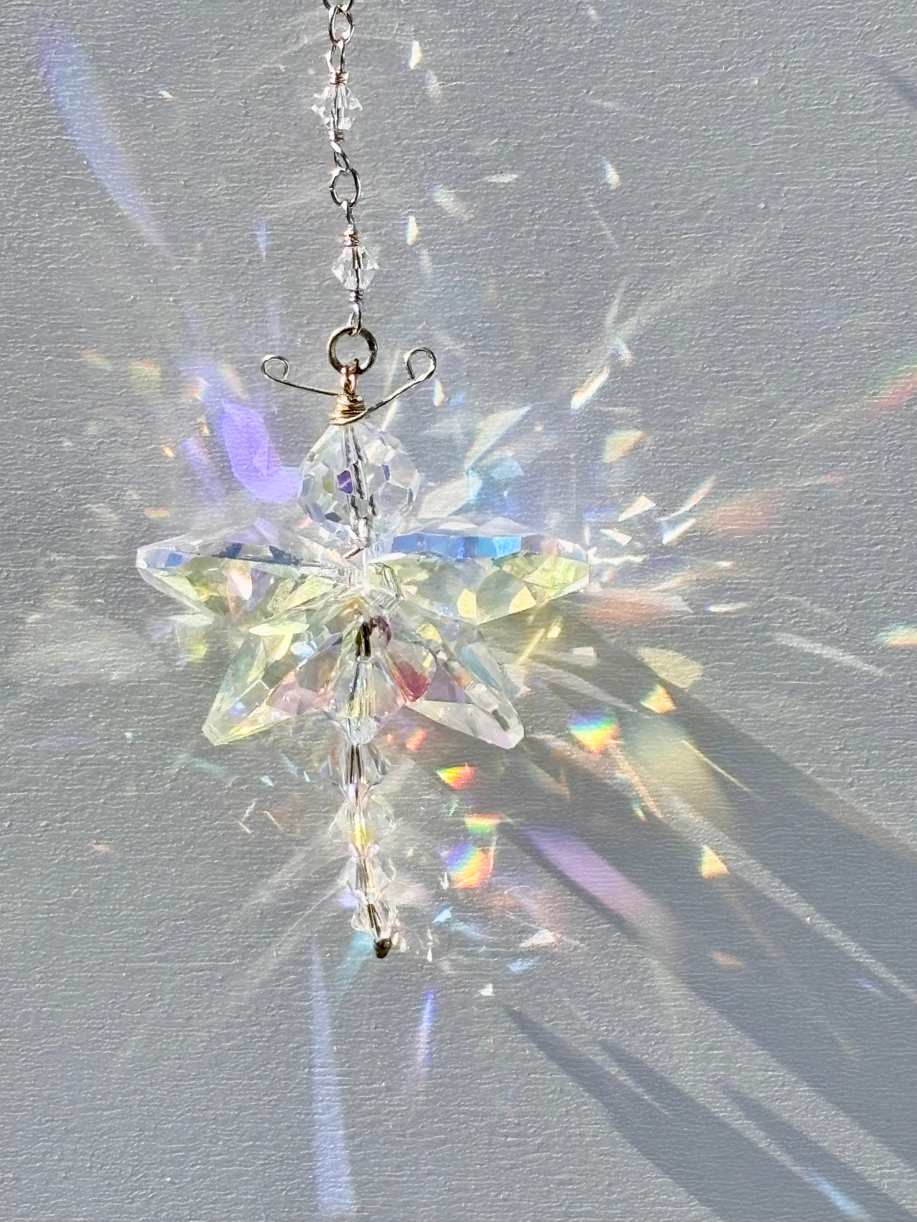 Unique artisan butterfly suncatcher made of rare Swarovski crystals being illuminated by the sun and casting amazing rainbows and sparkle.  