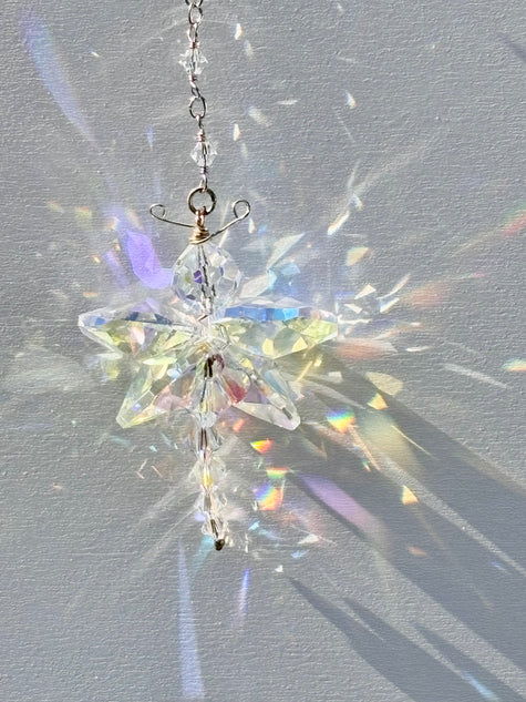 Unique artisan butterfly suncatcher made of rare Swarovski crystals being illuminated by the sun and casting amazing rainbows and sparkle.  