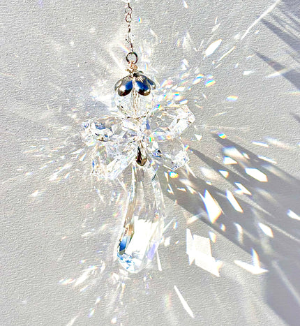 Unique handmade Fairy Angel suncatcher made from Swarovski crystals being illuminated by the sun and casting incredible prisms. 