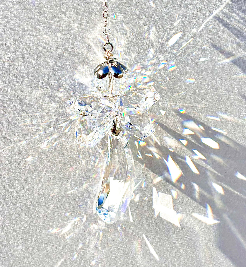 Unique handmade Fairy Angel suncatcher made from Swarovski crystals being illuminated by the sun and casting incredible prisms. 