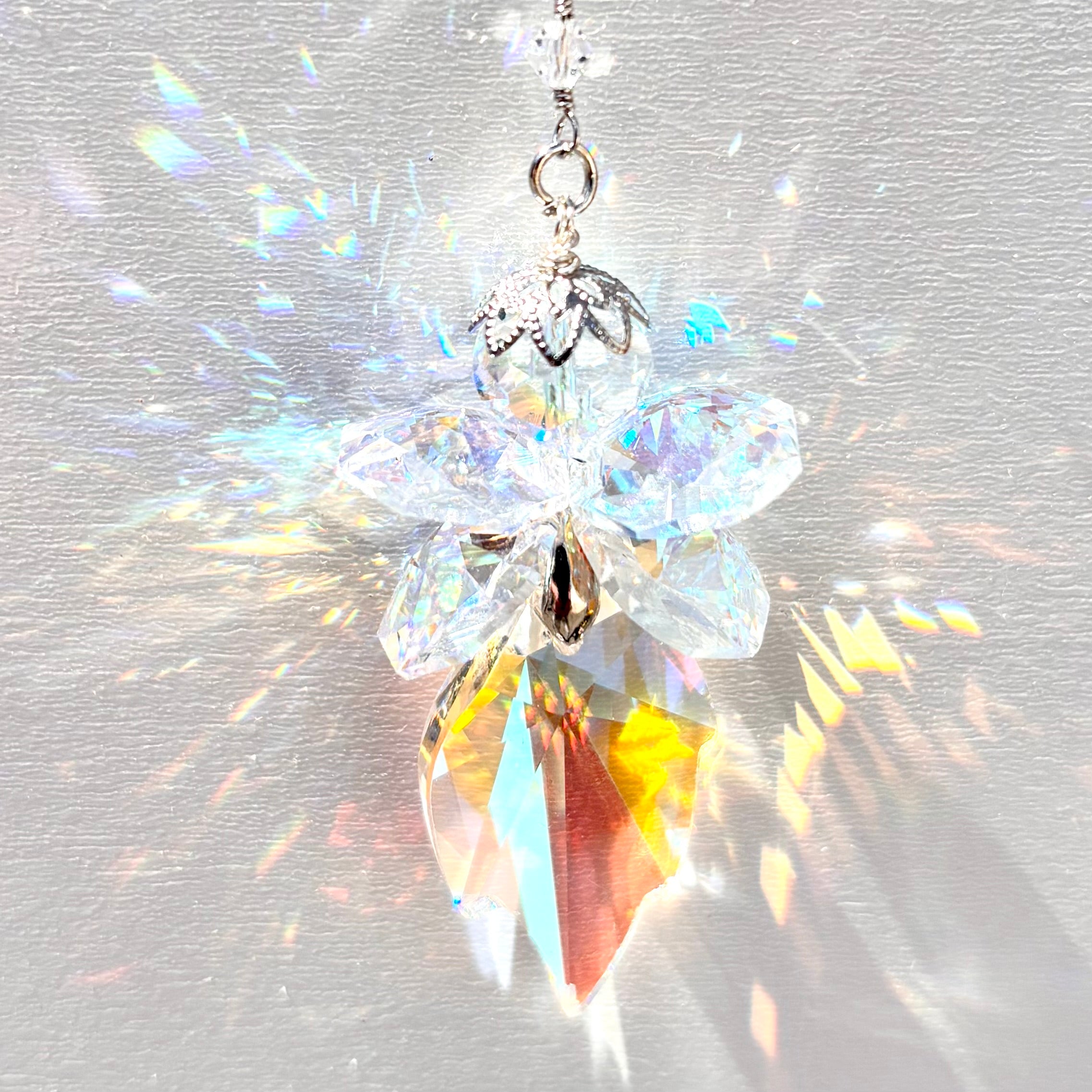 Handmade fairy suncatcher made with rare Swarovski Crystals with beautiful prisms of color when sunlight hits it. 