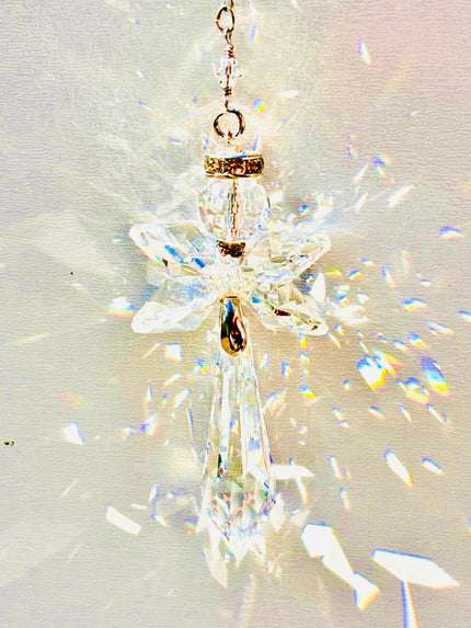Handmade angel suncatcher made with Swarovski crystals emitting prisms of colors as the sun hits it. 
