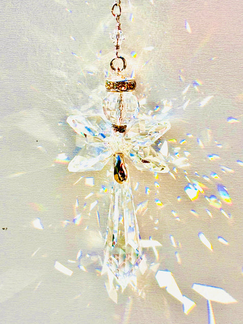 Handmade angel suncatcher made with Swarovski crystals emitting prisms of colors as the sun hits it. 
