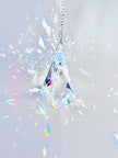 Rare Swarovski Vibe crystal hanging on a crystal strand emitting a magnitude of light and rainbows. 