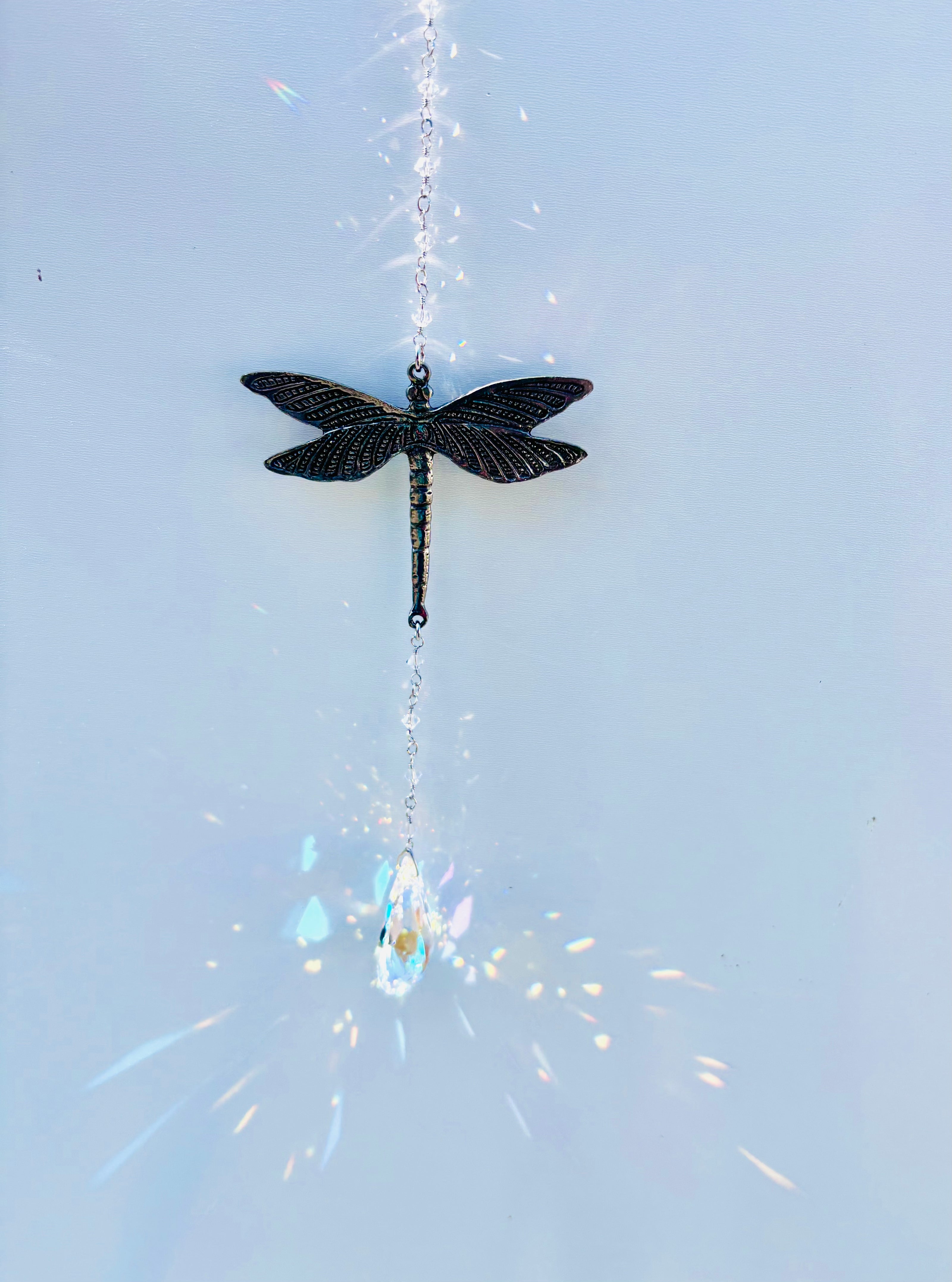 Decorative dragonfly ornament with crystals creating magical rainbows. 