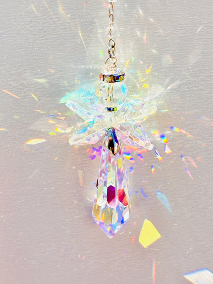 Handmade angel suncatcher glowing as the sun hits it creating a rainbow of colors.